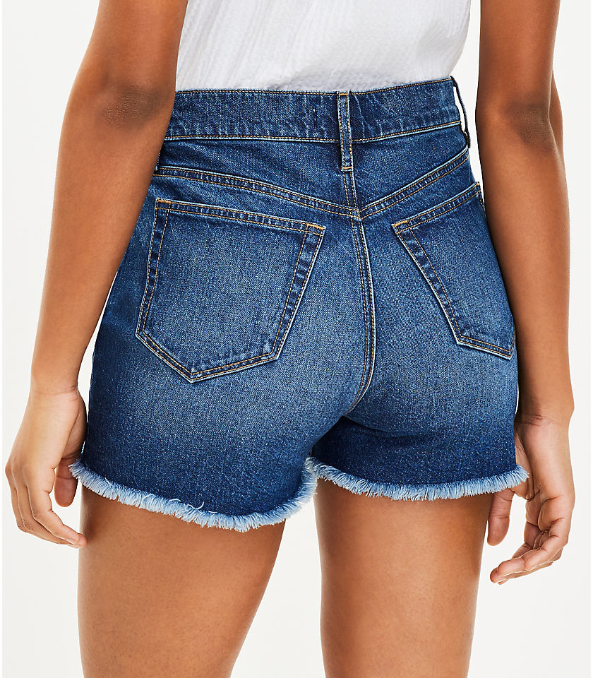Petite High Rise Frayed Cut Off Denim Shorts in Staple Mid Indigo Wash