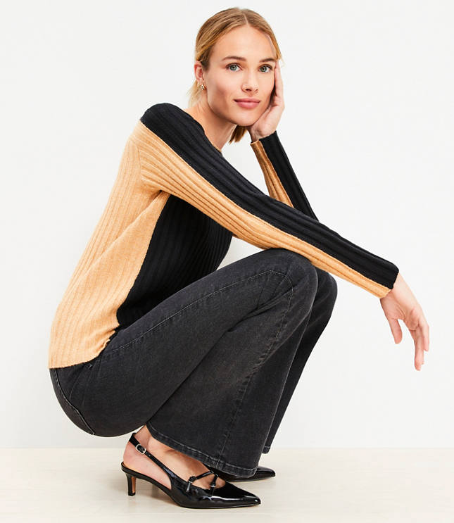 A woman wearing a brown and black sweater